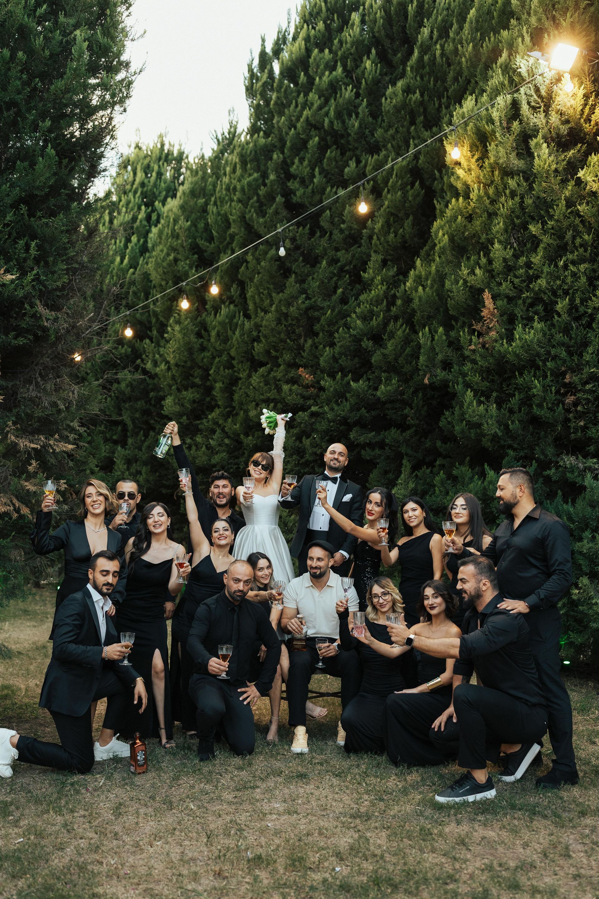 A bride and groom are posing for a picture with their wedding party.