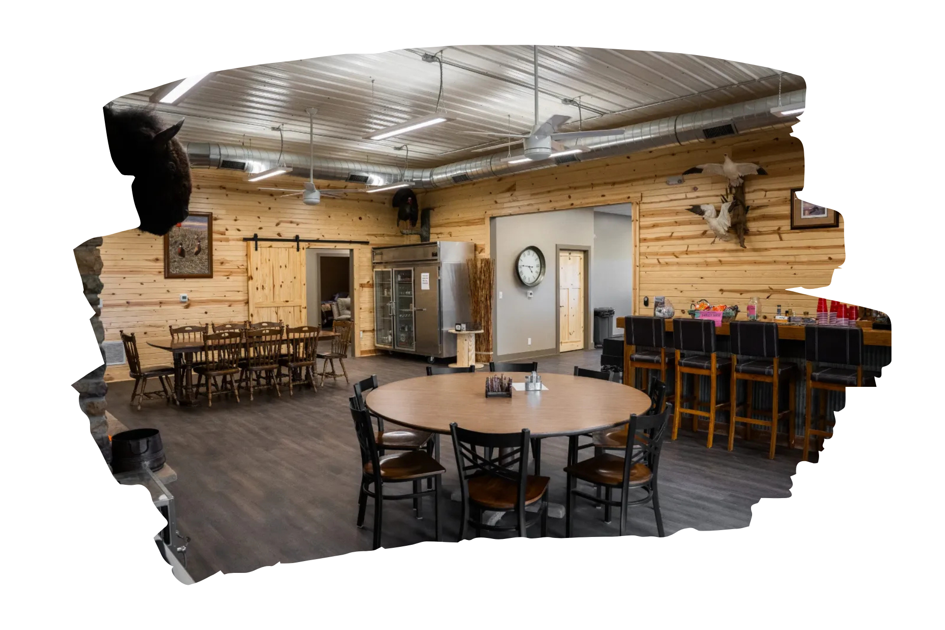 Bedroom with two beds, tan walls, gray carpet, rustic quilts.