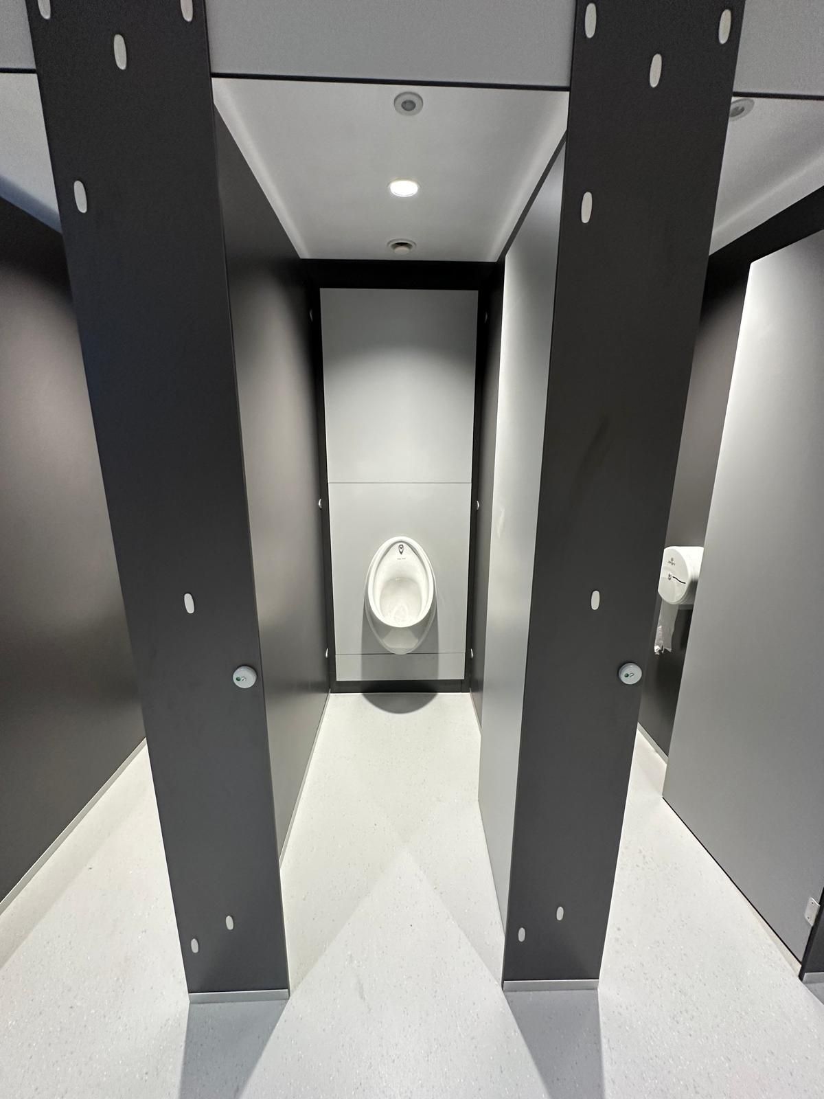 A bathroom with a toilet and a urinal in it