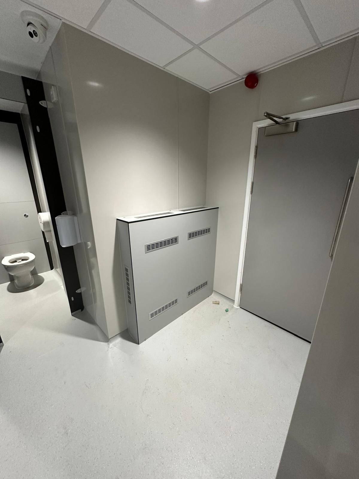 A bathroom with a toilet and a door.