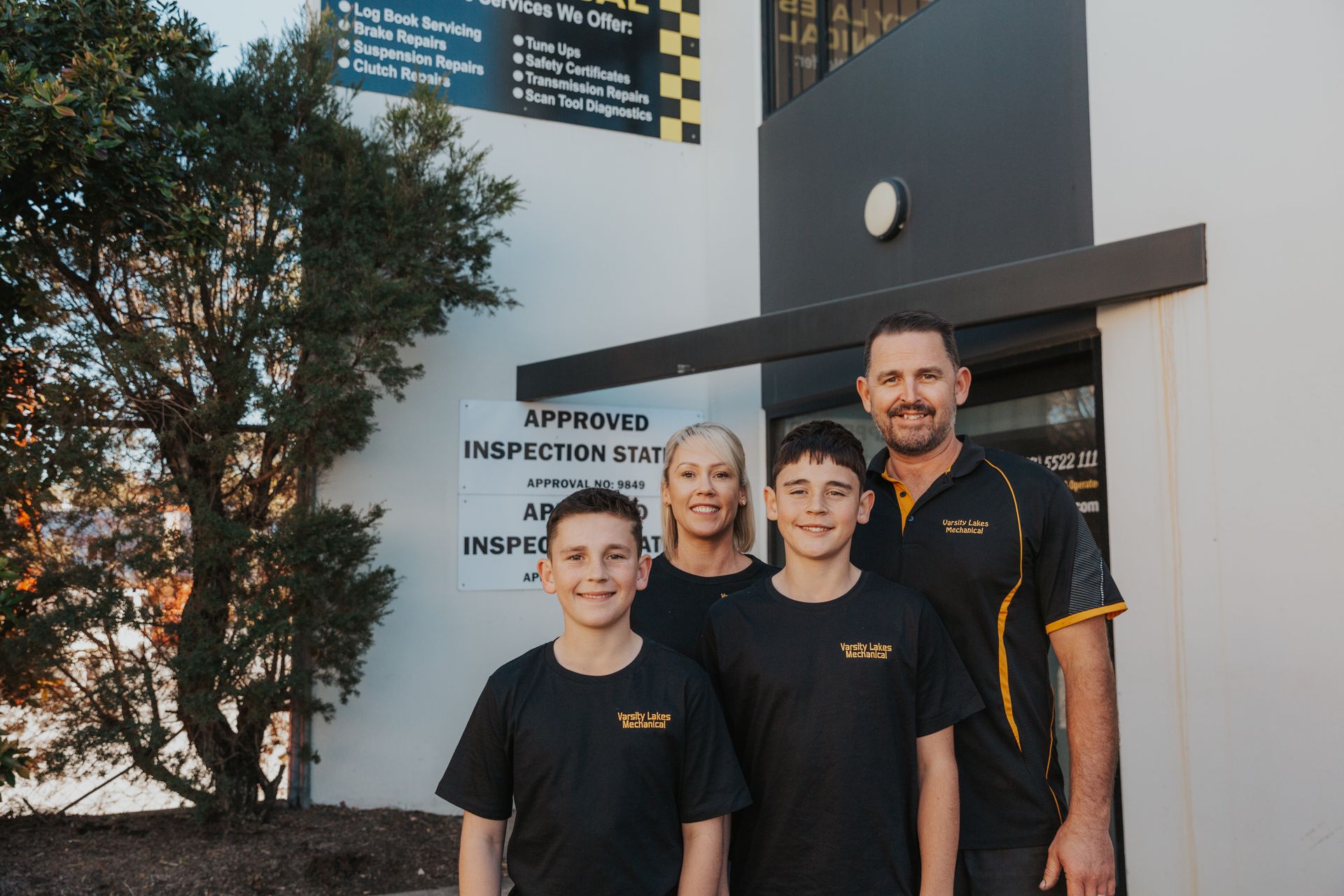 A Man and Woman Are Sitting in a Car With Two Children — Varsity Lakes Mechanical Repairs In Varsity Lakes, QLD