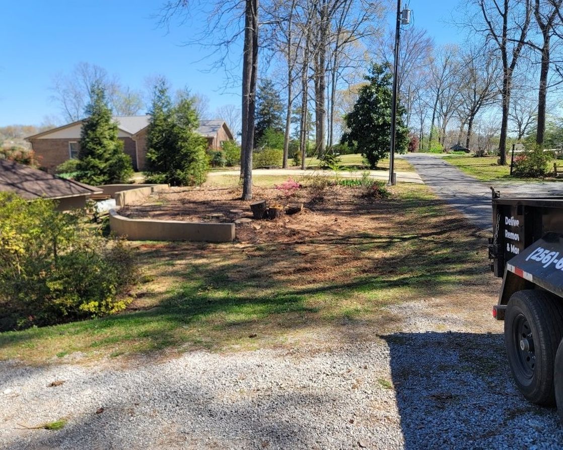 A dump truck is parked in the driveway of a house.