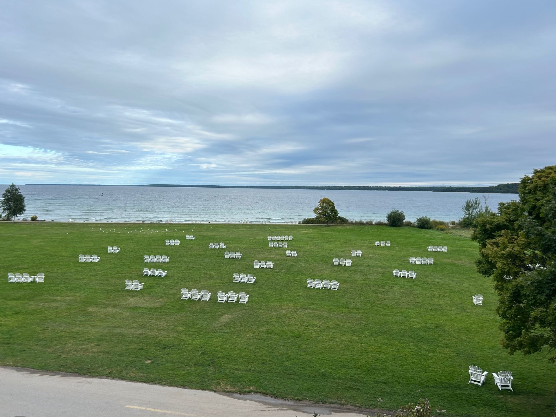 A large grassy field with a body of water in the background.