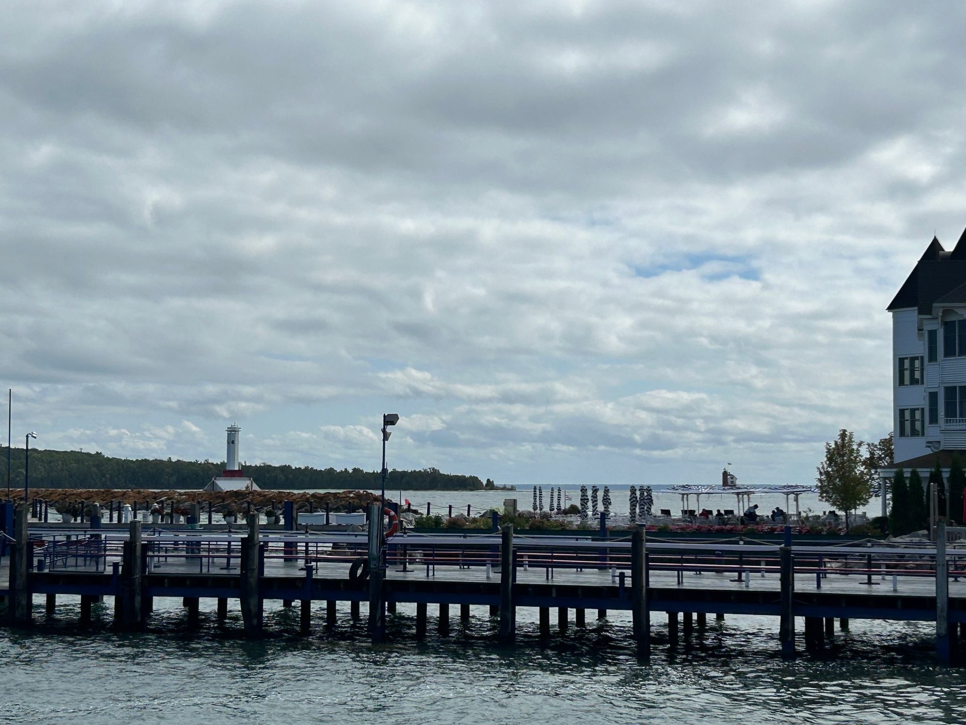A dock overlooking a body of water with a building in the background