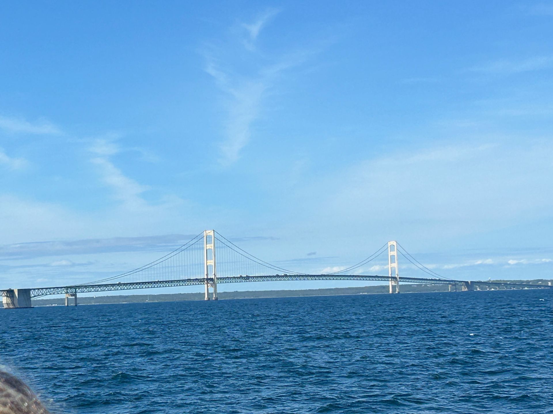 A bridge over a body of water with a blue sky in the background.