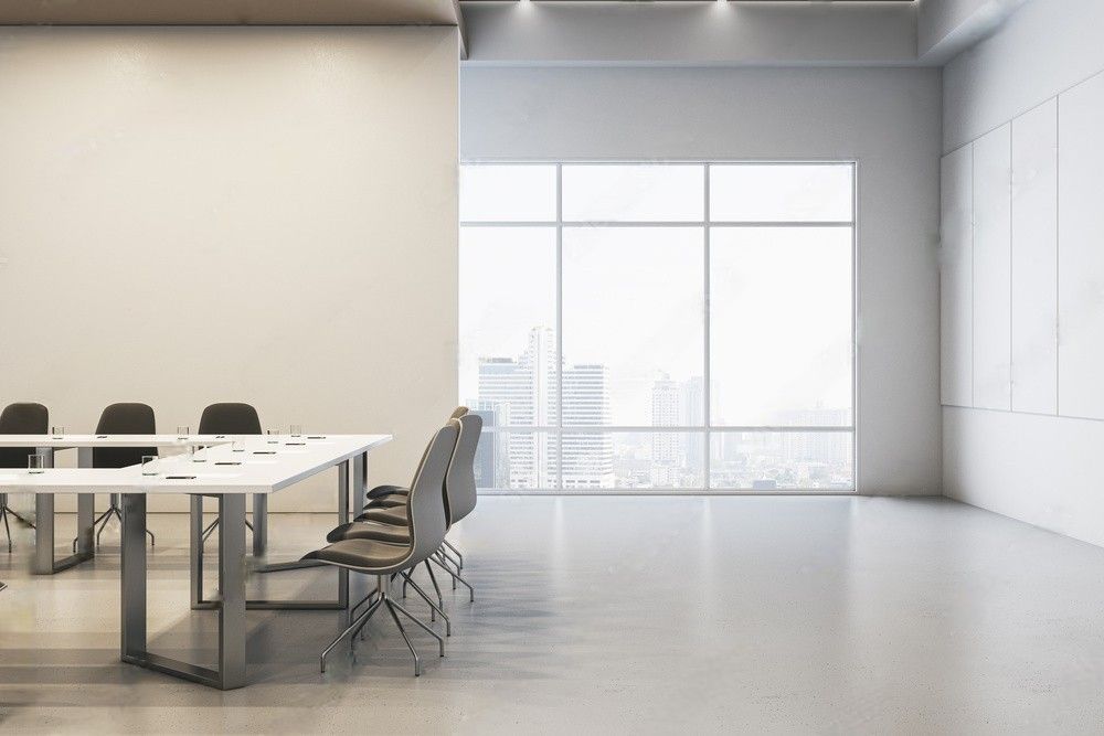 Clean and well-lit concrete meeting room with a modern, minimalist design.