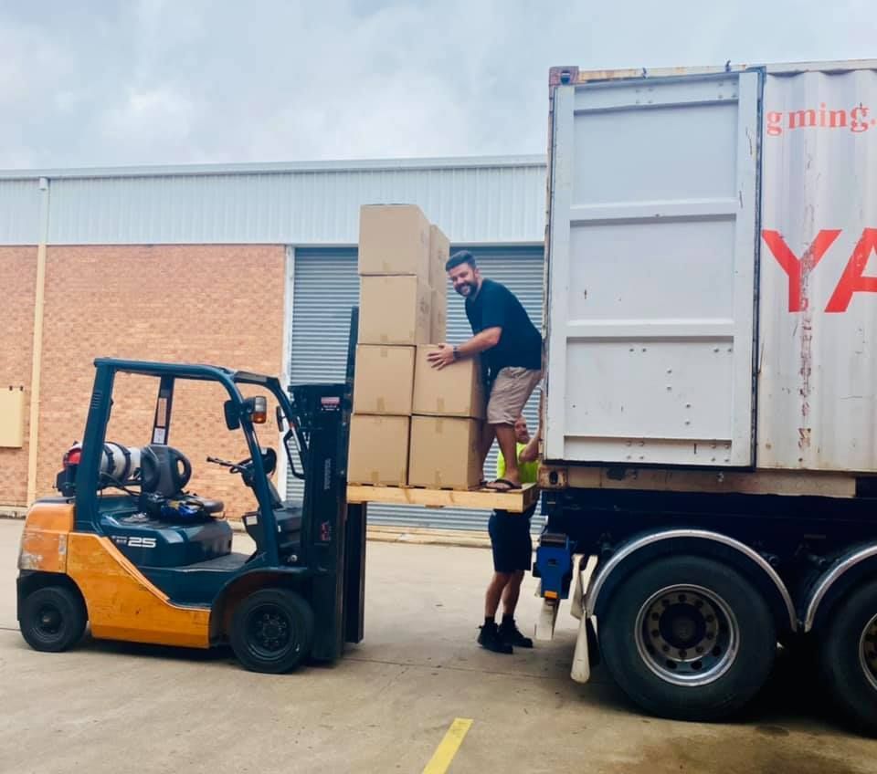 Man is Loading Boxes Onto a Ya Truck — Grants Express in Blacktown, NSW