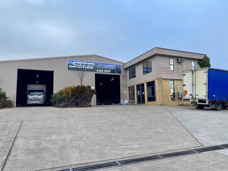 Large Building With a Blue Truck Parked in Front of It — Grants Express in Orange, NSW