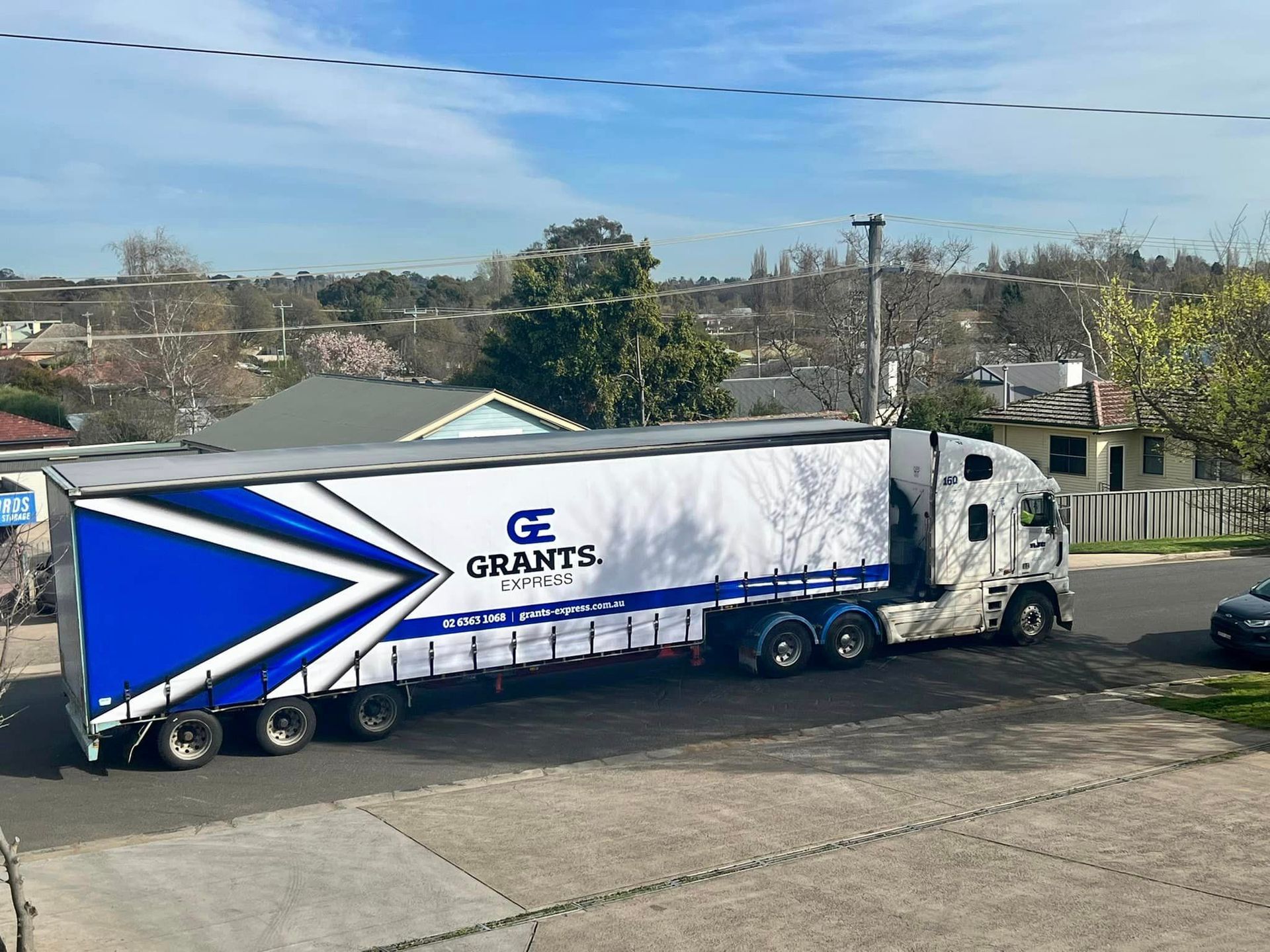 Blue and White Semi Truck is Parked on the Side of the Road — Grants Express in Lithgow, NSW