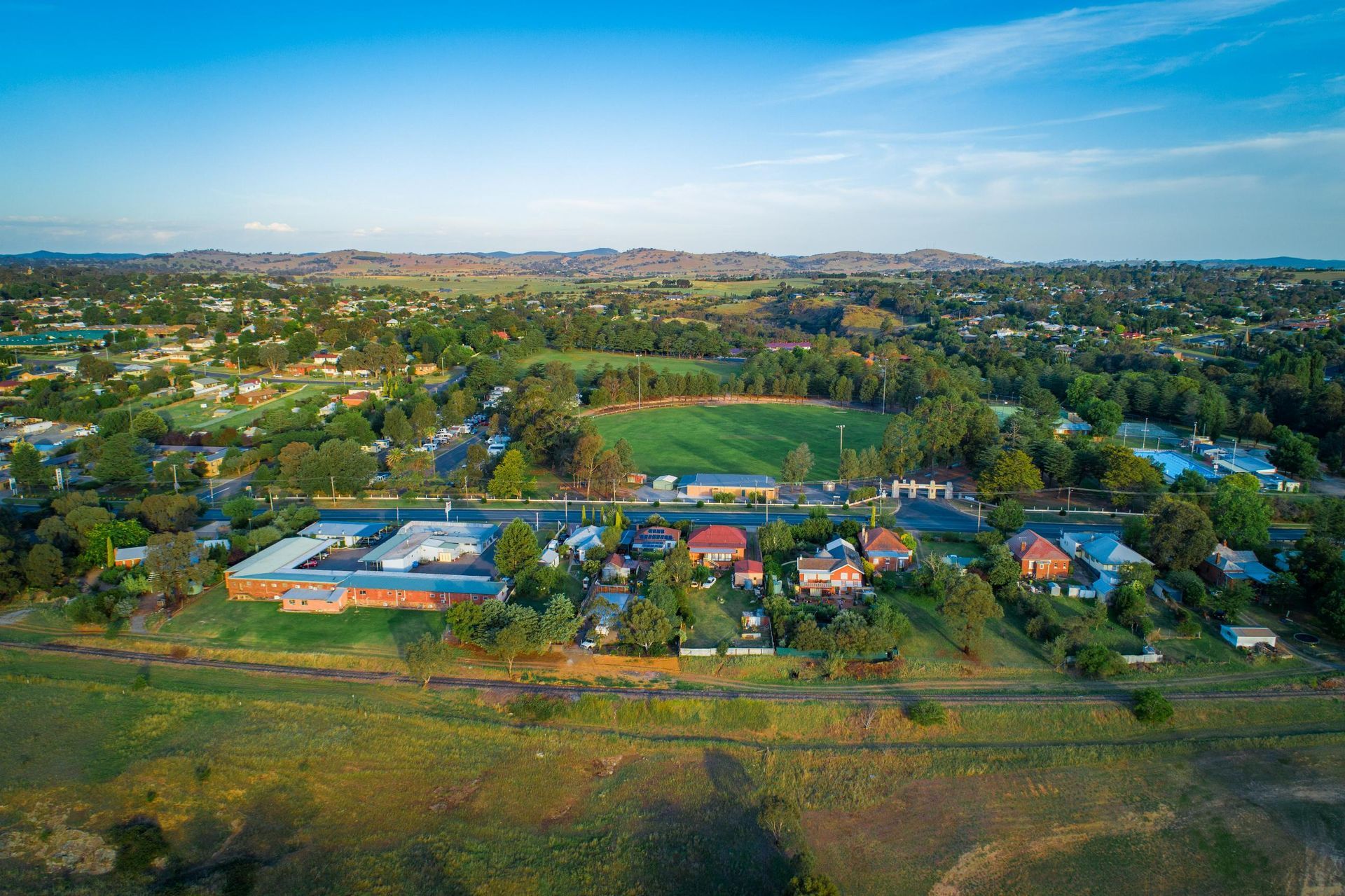 Aerial View of a Small Town With a Field in the Middle of It — Grants Express in Eastern Creek, NSW