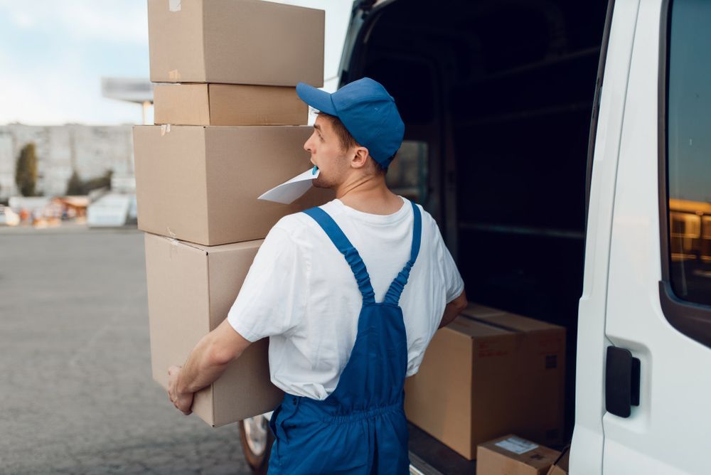 Delivery Man is Loading Boxes Into a Van — Grants Express in Parkes, NSW