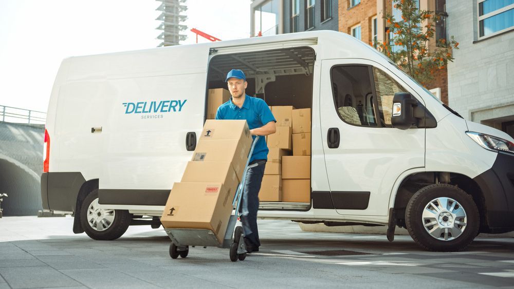 Delivery Man is Loading Boxes Into a Delivery Van — Grants Express in Mudgee, NSW