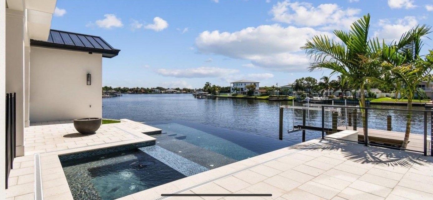 A large swimming pool is surrounded by a large body of water.