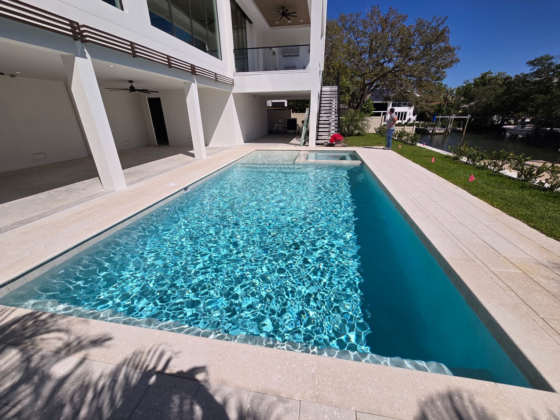 A large swimming pool in front of a house