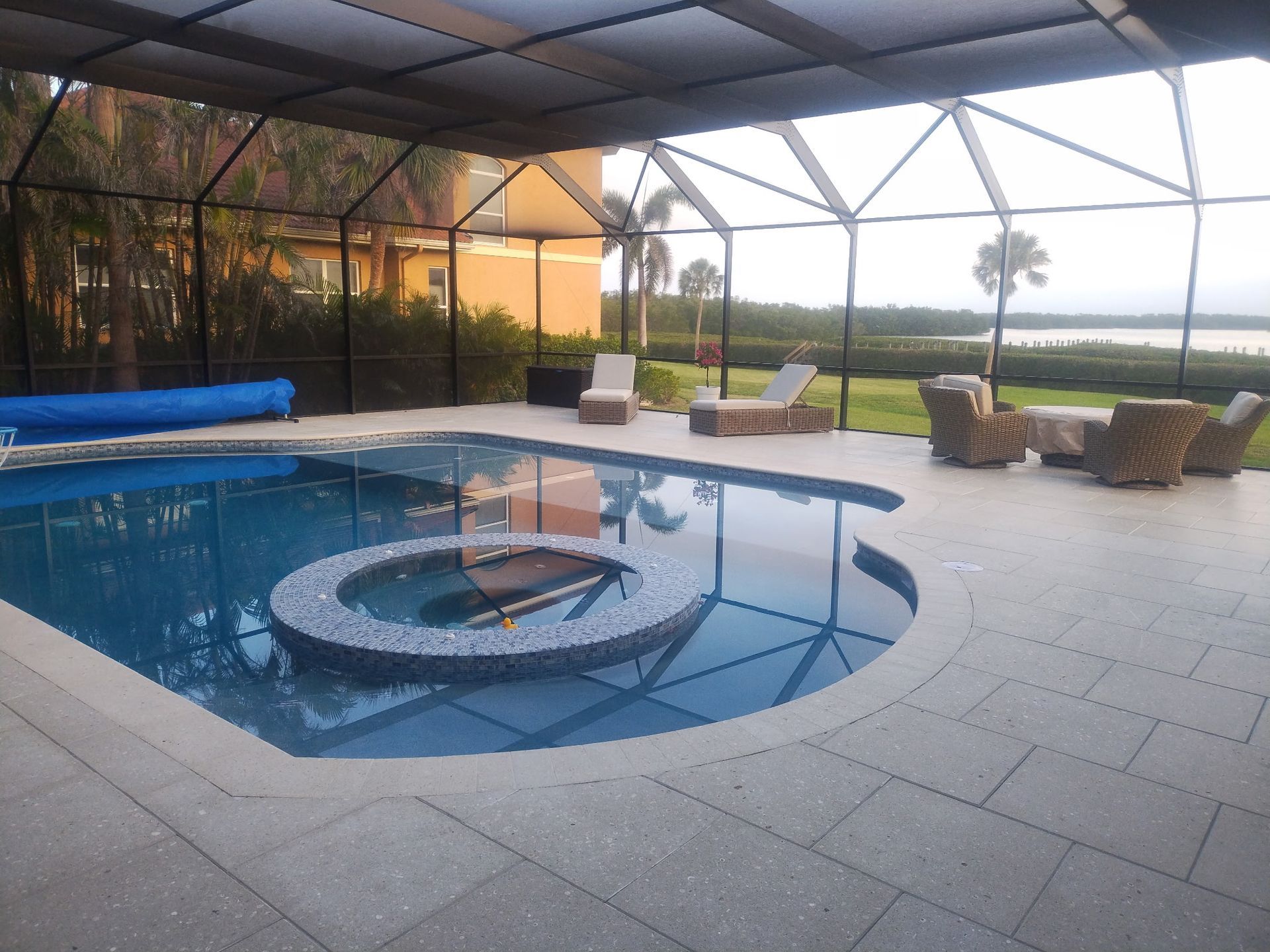 A large swimming pool with a hot tub in the middle