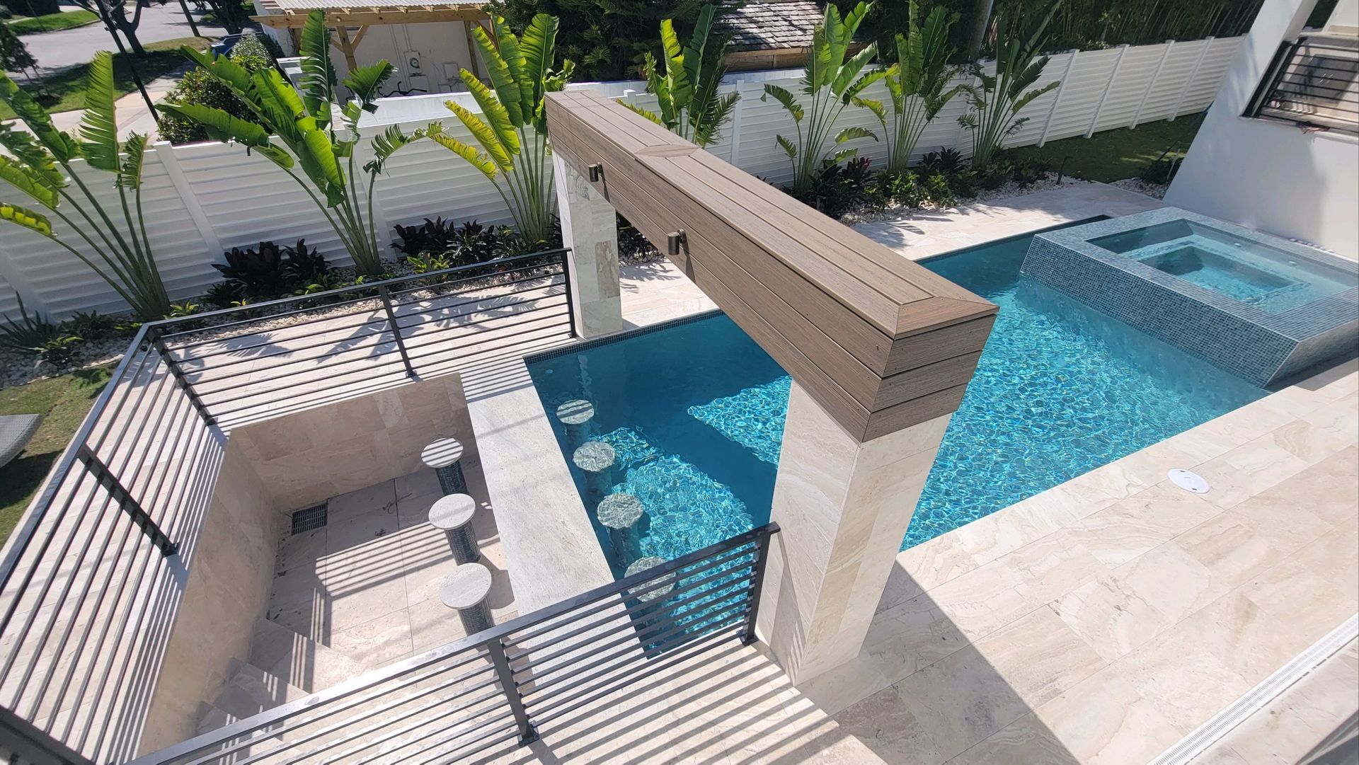 An aerial view of a large swimming pool and hot tub