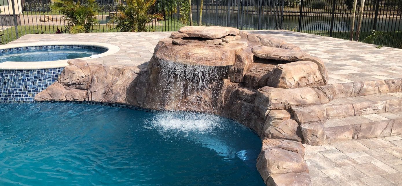 There is a waterfall in the middle of the pool.