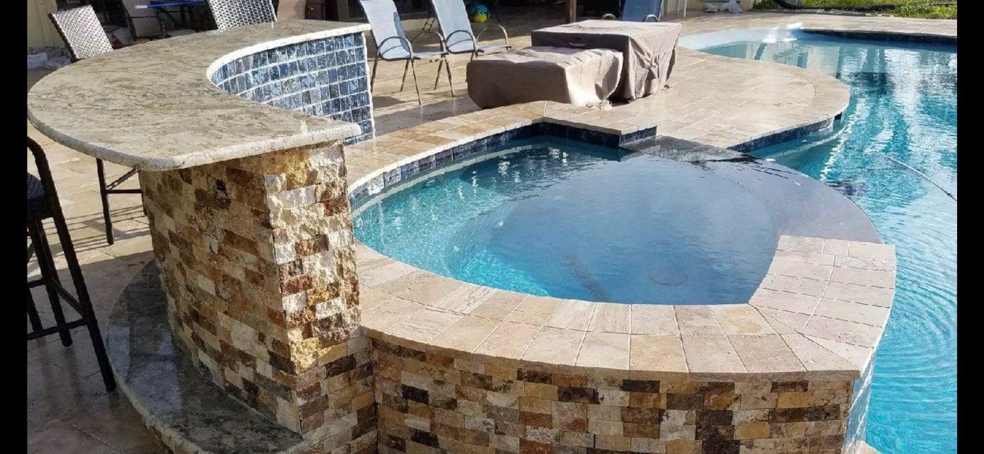 A large swimming pool with a bar in the middle of it.