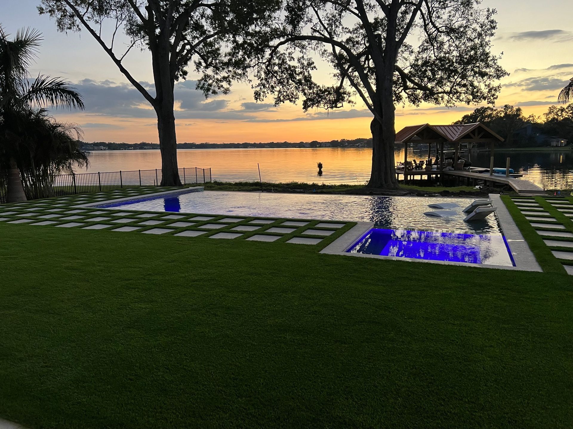 A large swimming pool with a hot tub in the middle