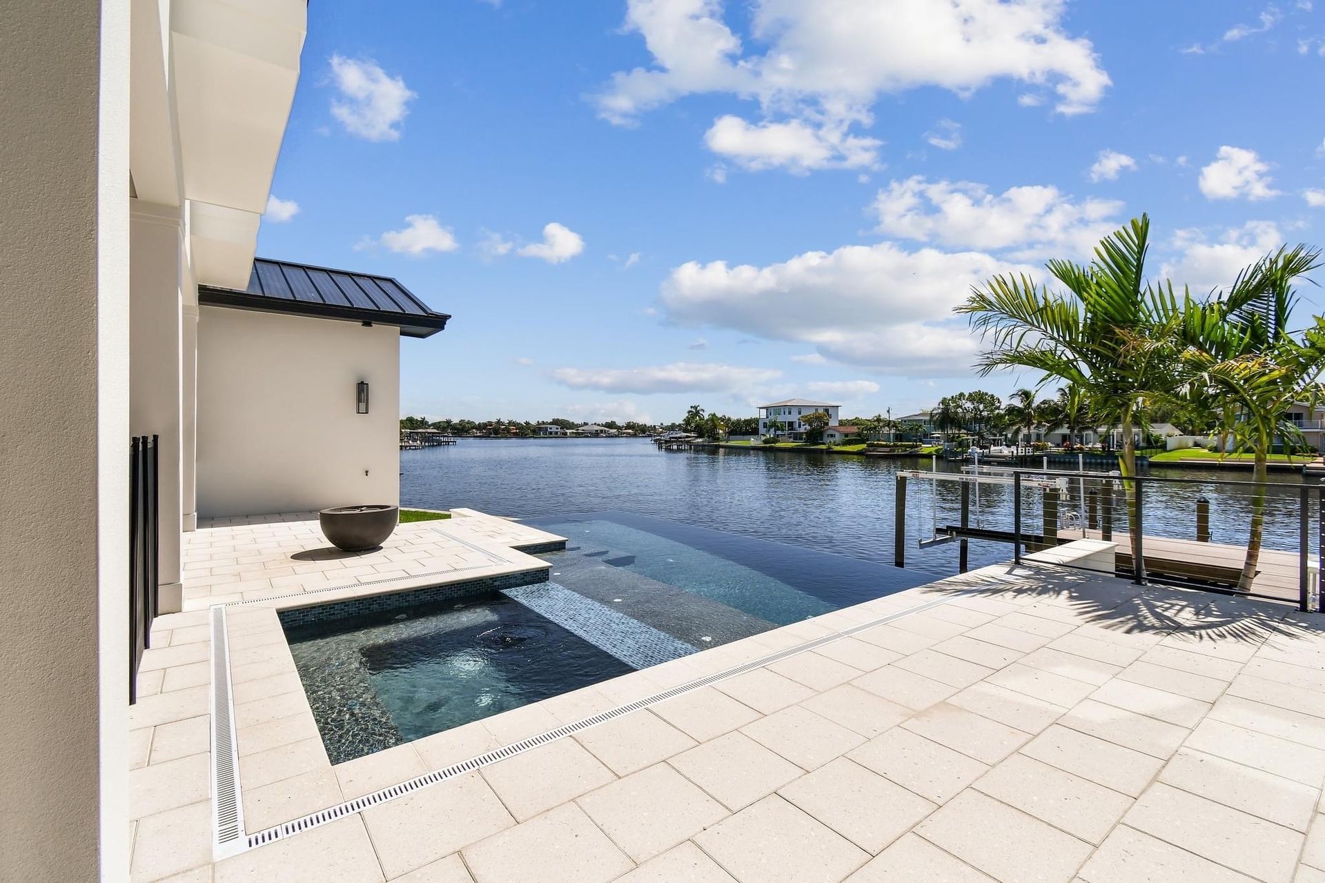 A large swimming pool is surrounded by a large body of water.