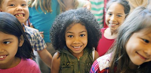 Group of diverse children smiling together.