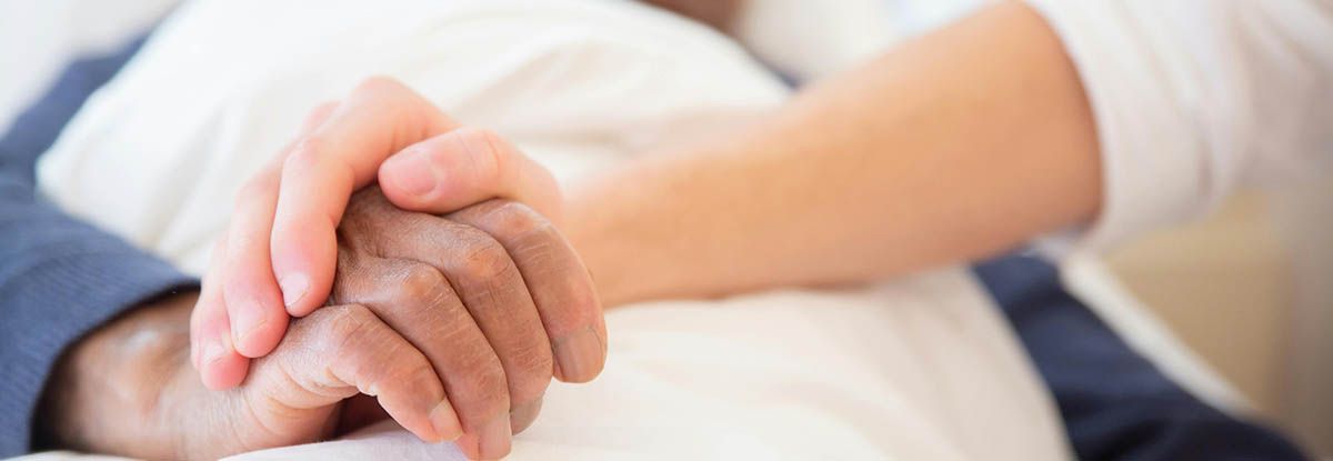 Two hands clasped together, possibly offering comfort and support.