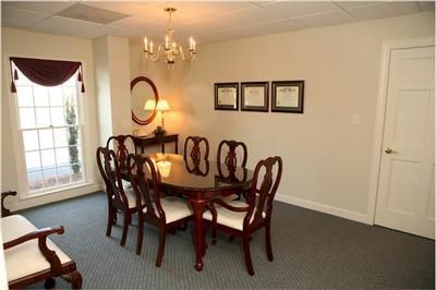 A conference room with a round table and chairs