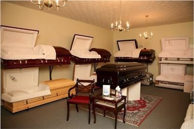 A room filled with lots of coffins and chairs