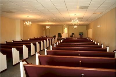 Rows of purple benches in an empty church