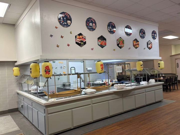 Buffet with trays of rice and vegetables; blurry background with fruit. Buffet with trays of rice and vegetables; blurry background with fruit.