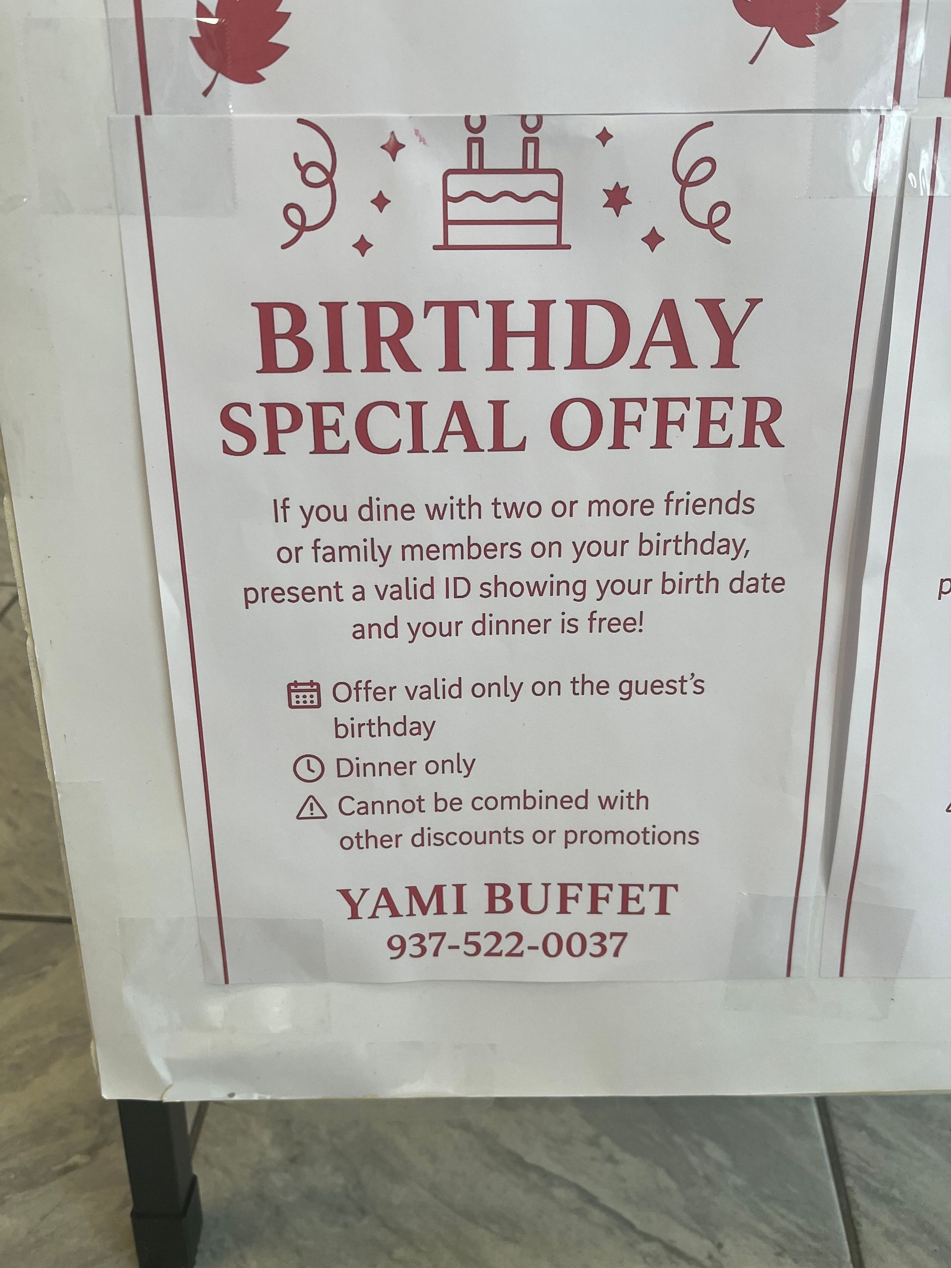 A sign advertising a birthday special offer at Yami Buffet with text and a cake graphic.