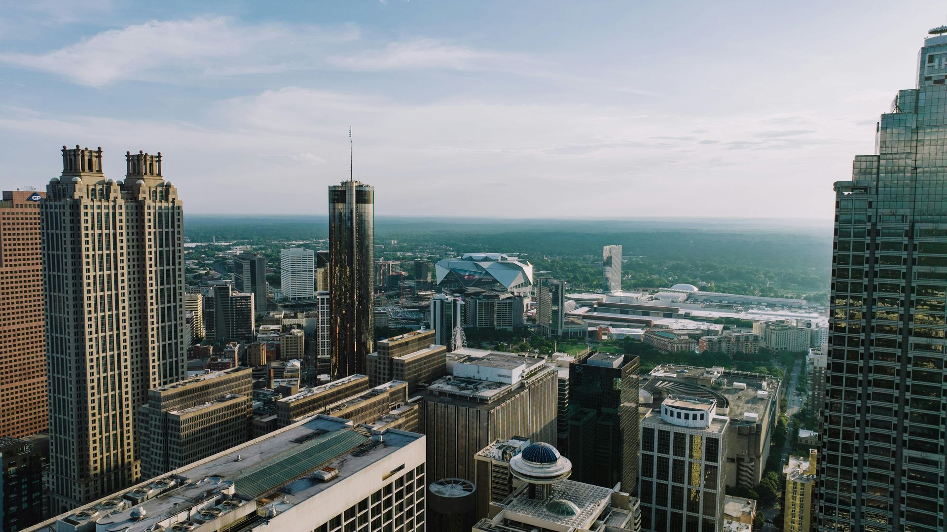 City skyline under a blue sky, skyscrapers and stadium visible, Atlanta, Georgia.