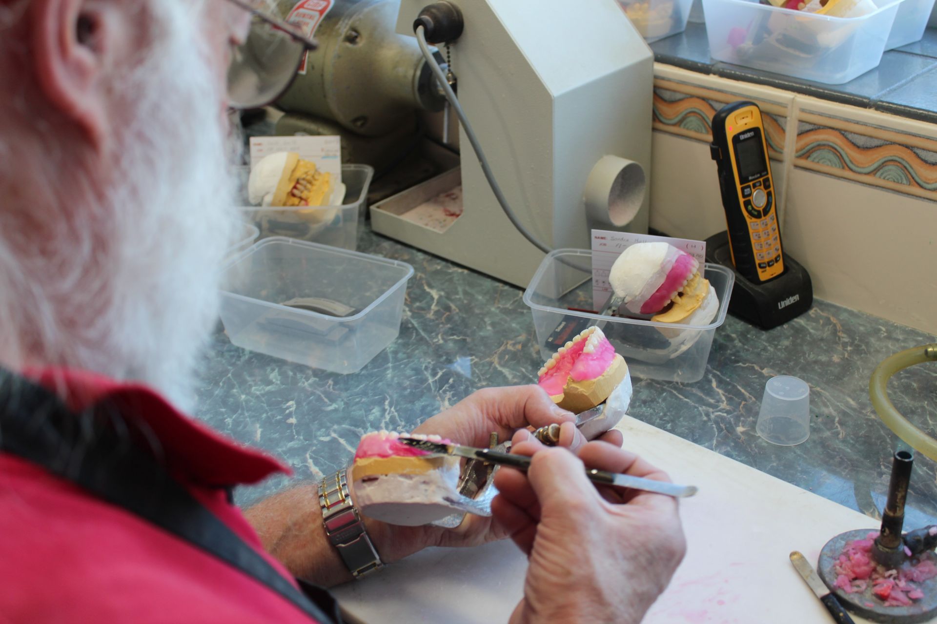 Men working on a new set of dentures — Dentures in Toukley, NSW