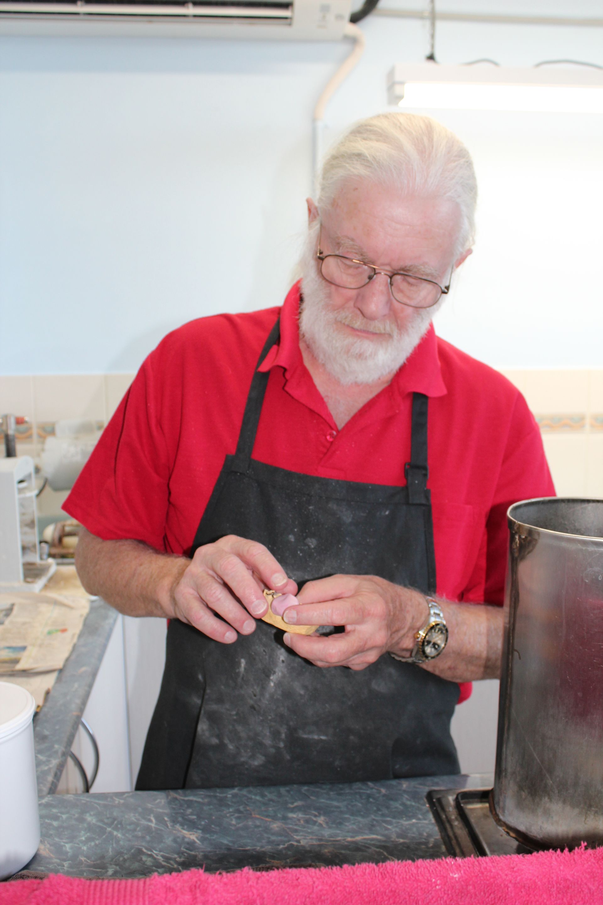 Man working on a new set of denture — Dentures in Toukley, NSW