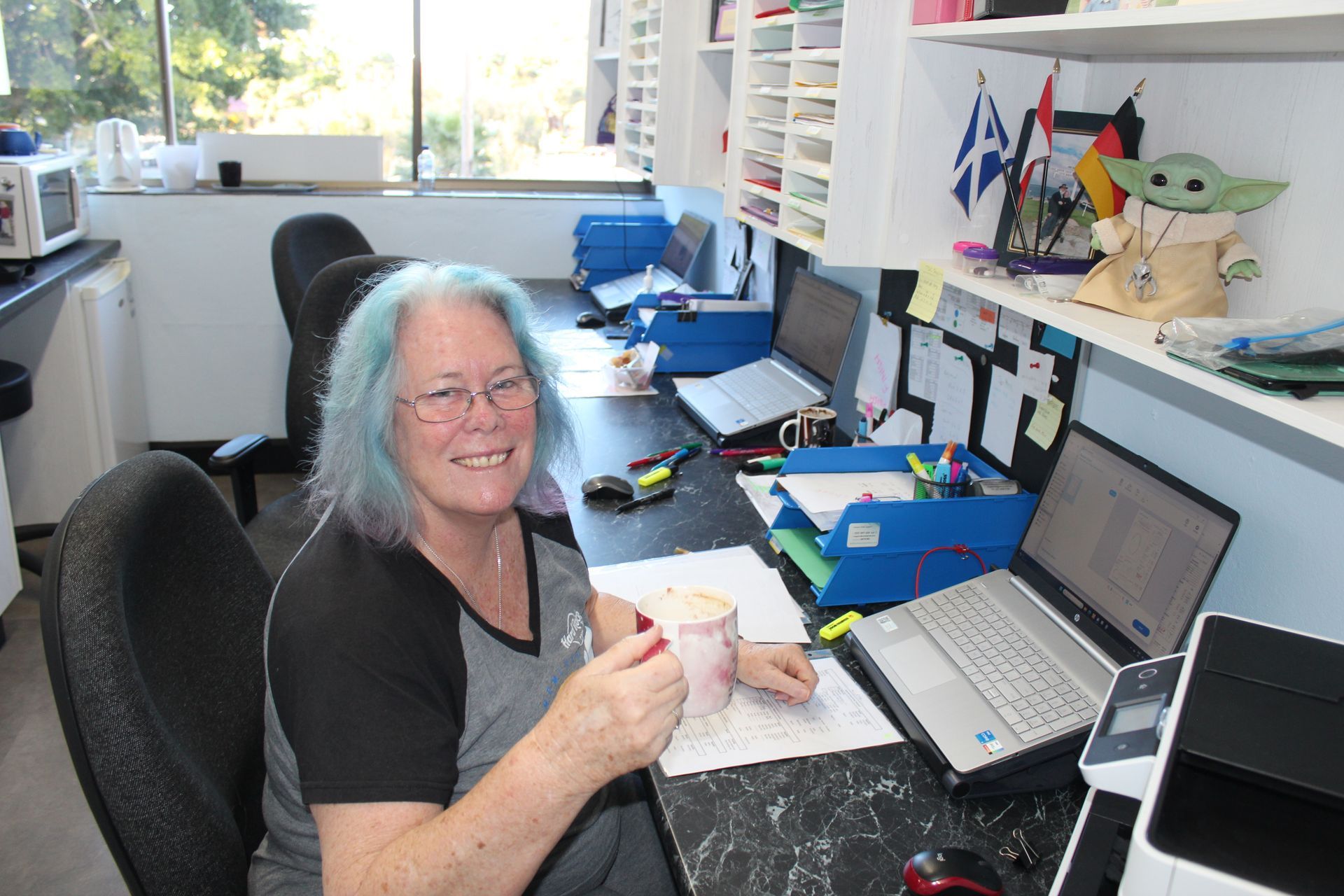 Woman working at the computer sorting out appoitments for new dentures work — Dentures in Toukley, NSW