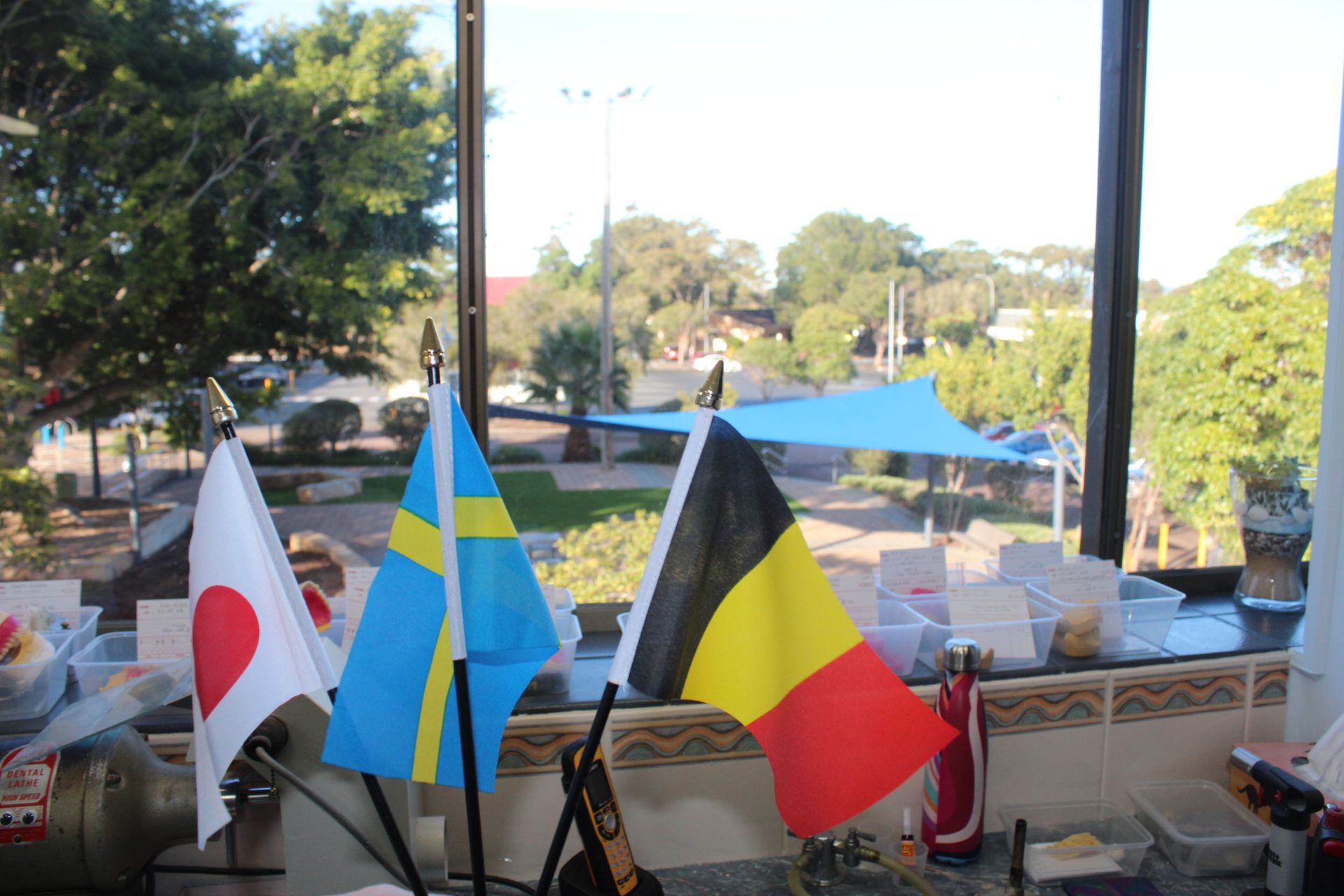 American flag, LGTBQ+ fag and the Australian flag on a reception desk — Dentures in Toukley, NSW