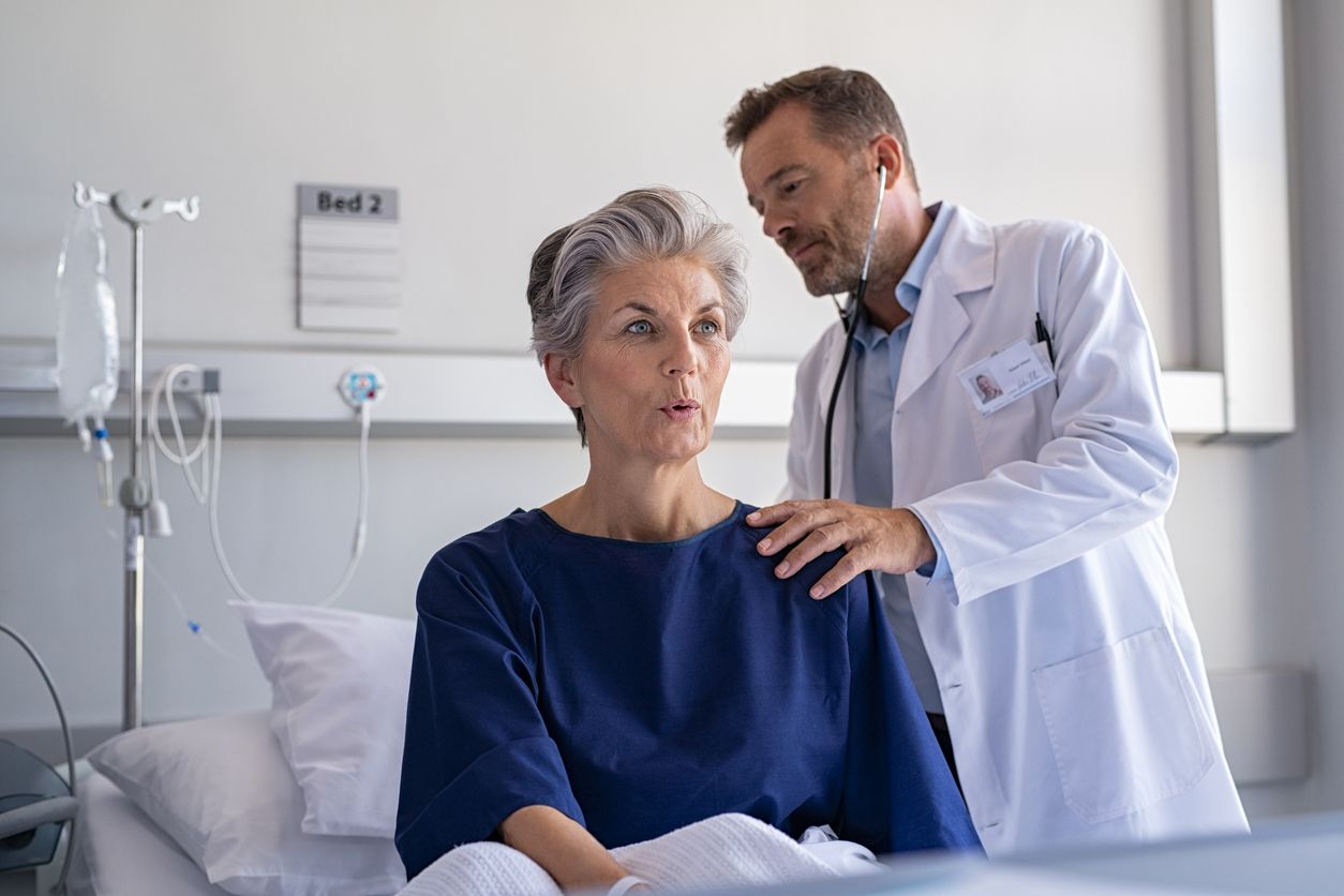 Doctor Instructs Patient on Breathing Exercises