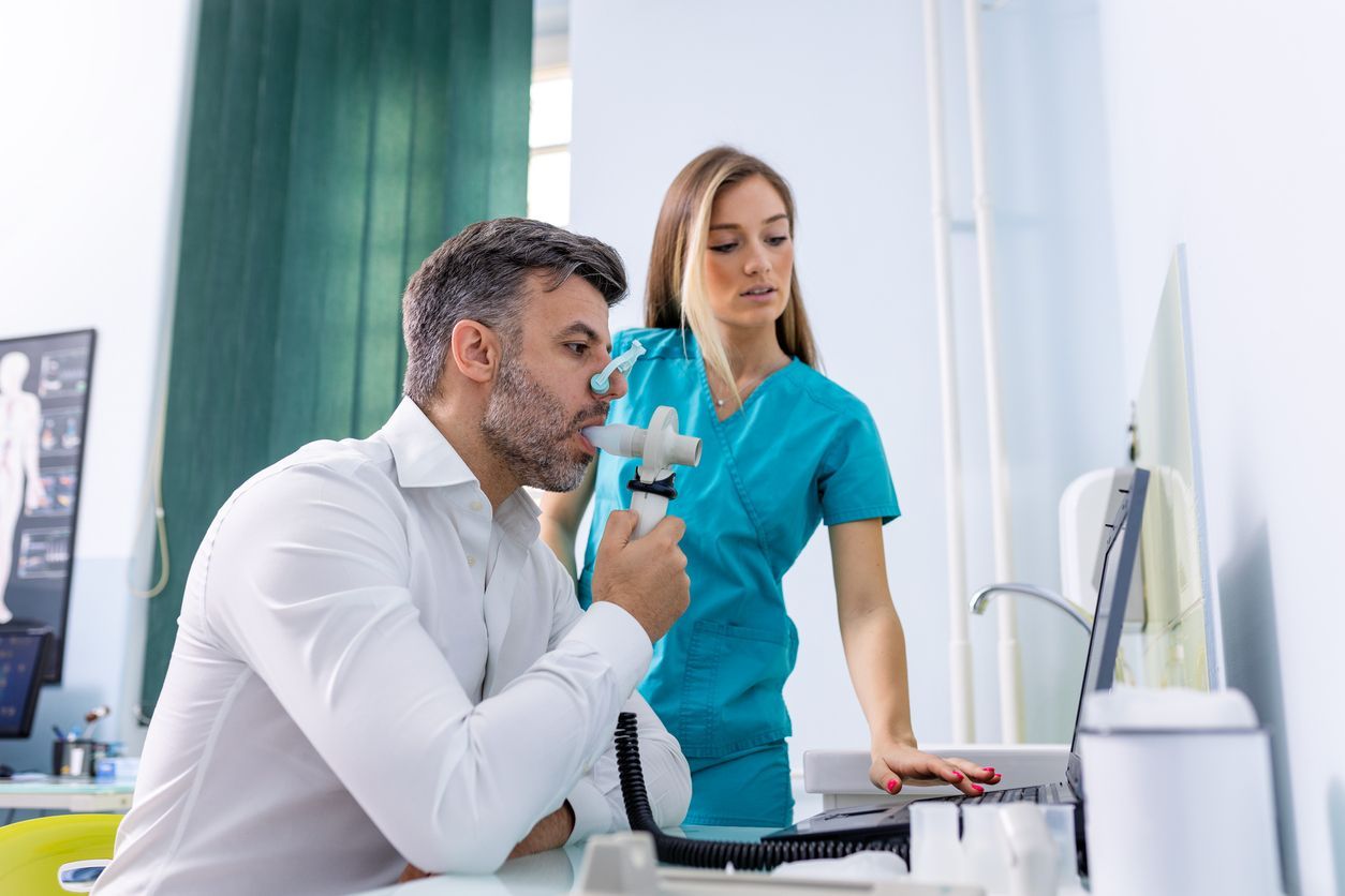 A man is being examined by a nurse in a hospital.