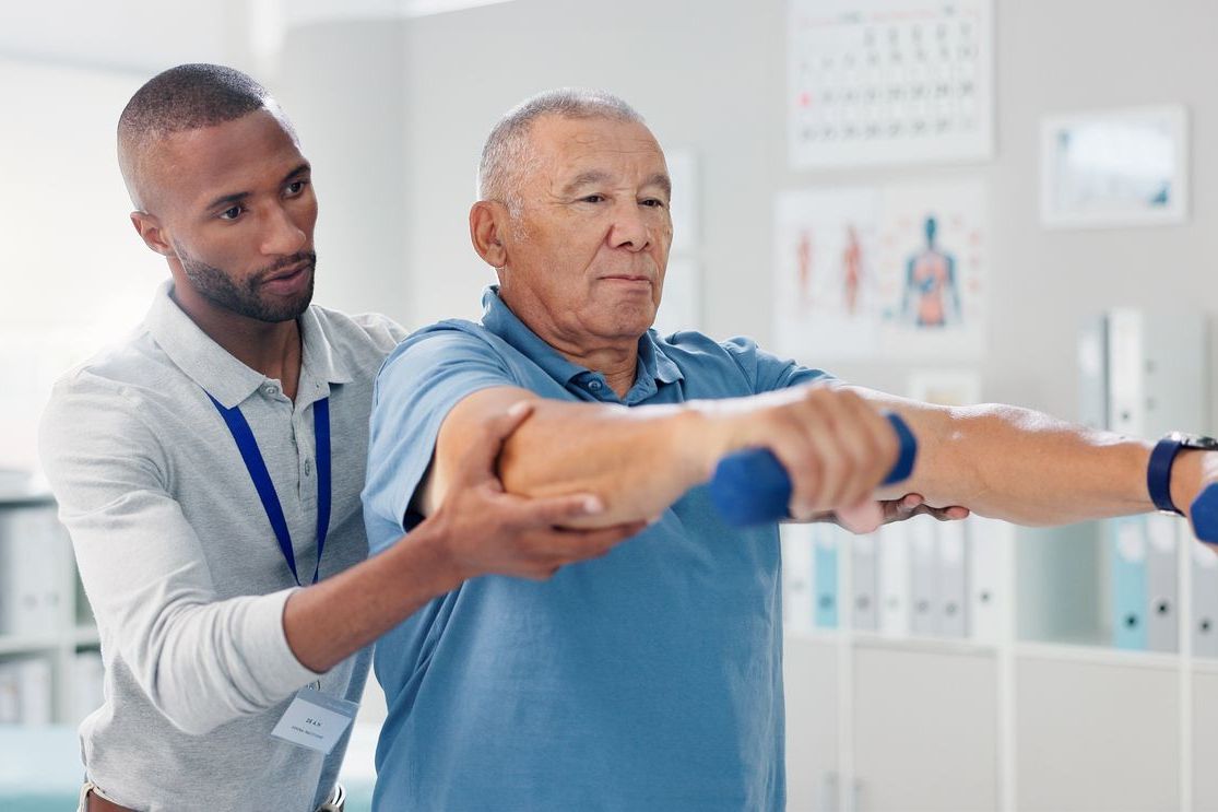 A doctor is talking to a patient in a hospital bed.