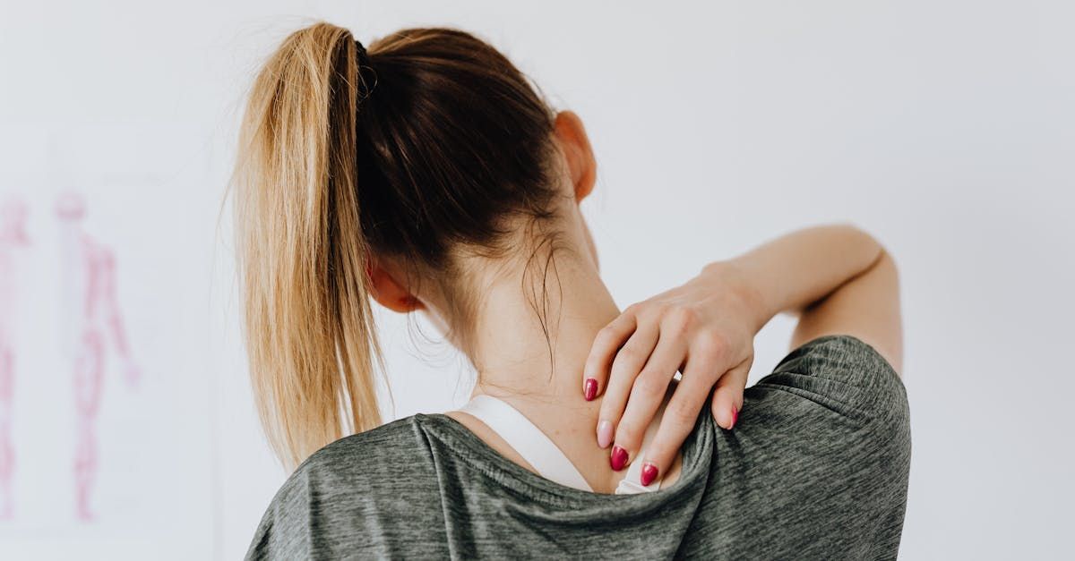 a woman holding her shoulder 