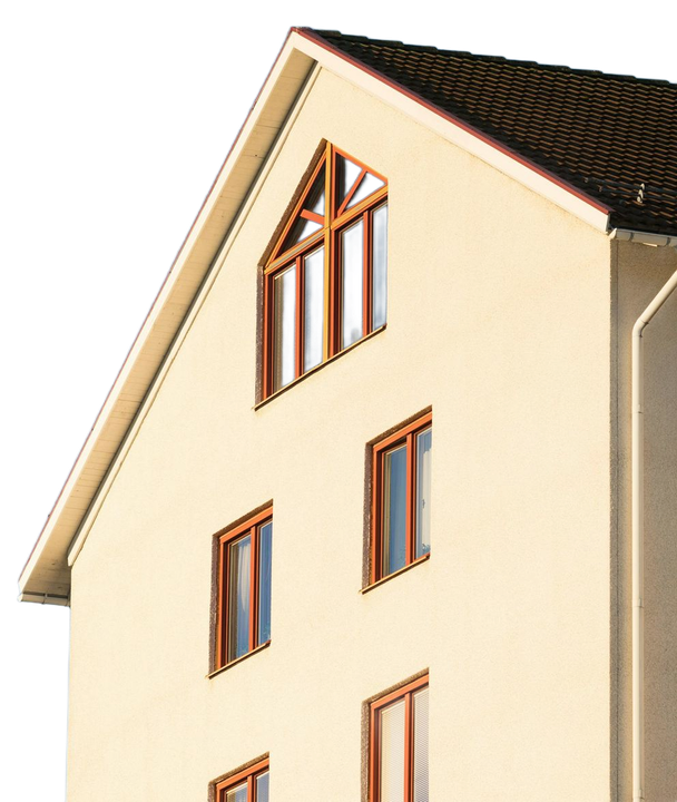 Beige building with multiple brown-framed windows; triangular window at top, brown roof.