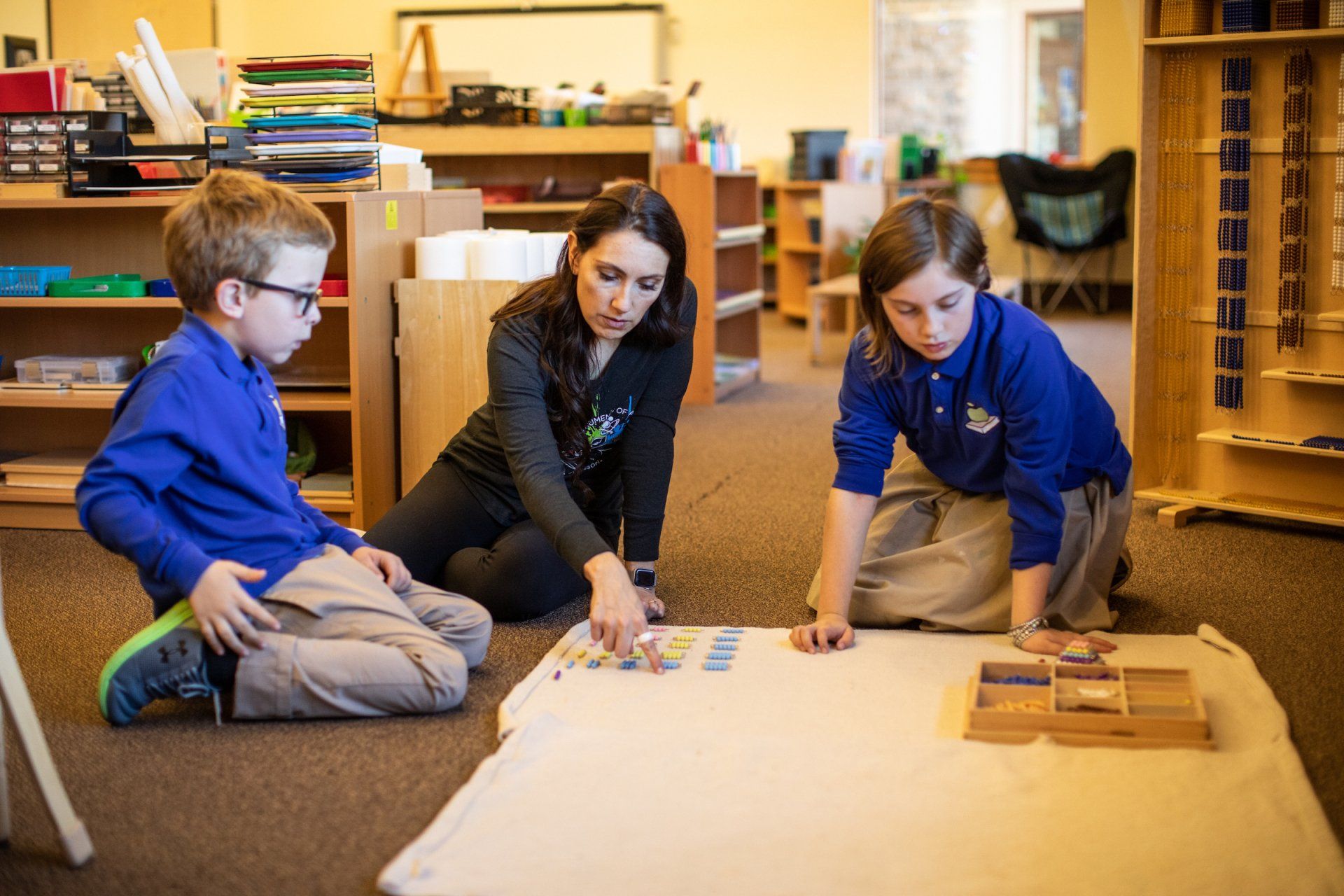 Montessori students and guide in the classroom