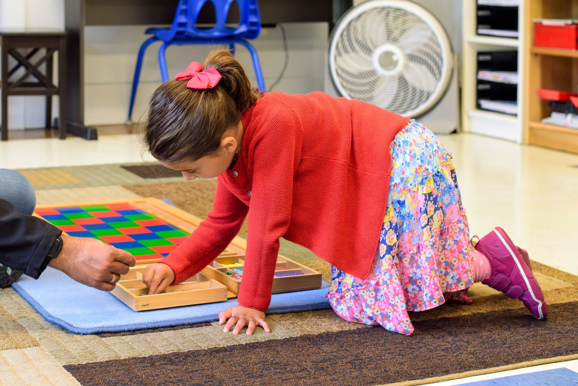 Montessori child working with math materials