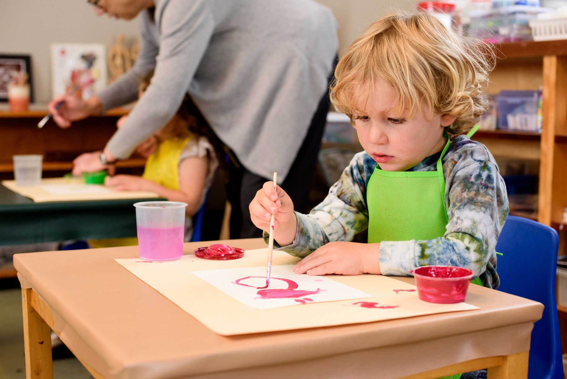 Montessori child painting in the classroom