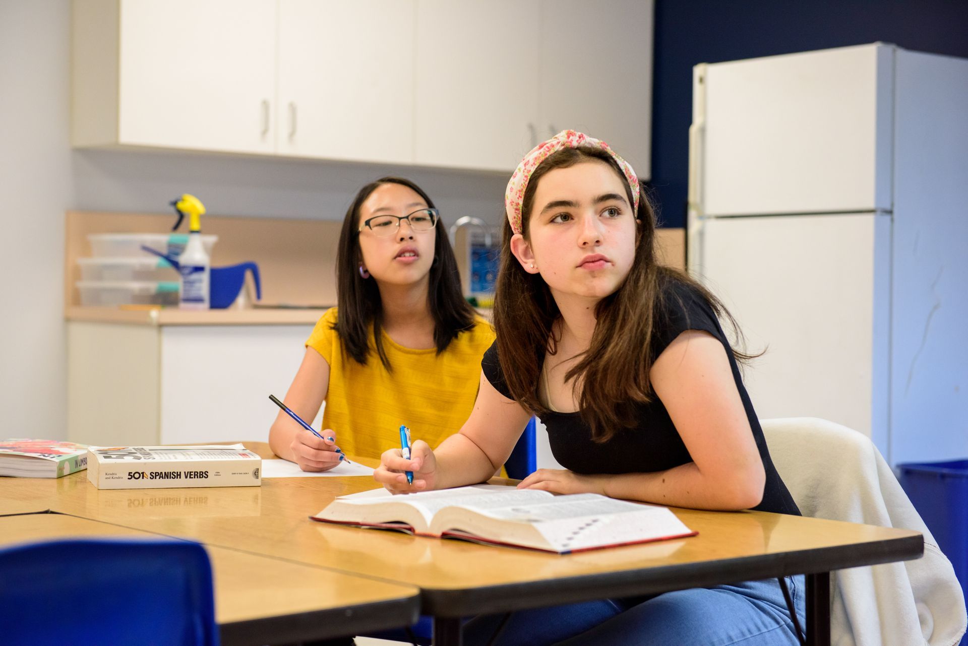 two montessori students working in the classroom