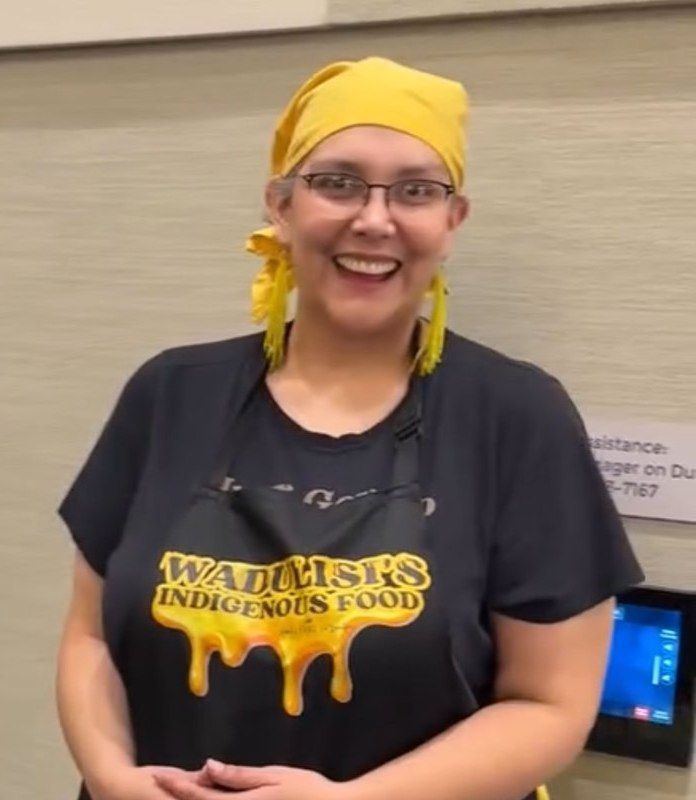 Melissa in a Wadulisi's Indigenous Food apron at an event