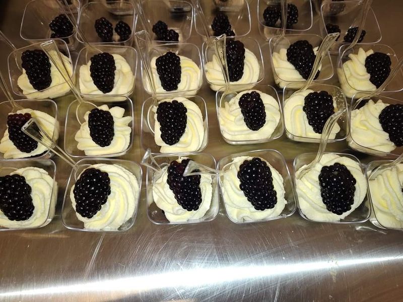 Individual dessert cups topped with blackberries