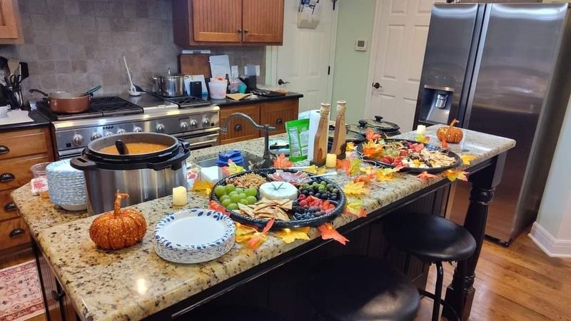 A home kitchen island set with seasonal boards and soup