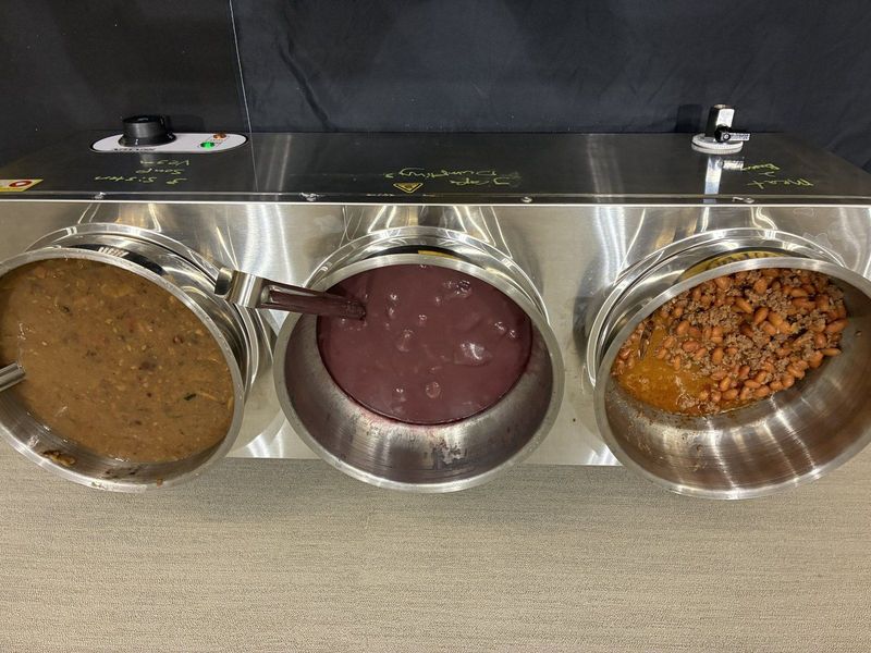 Three warmers holding meat and beans, grape dumplings and Three Sisters soup