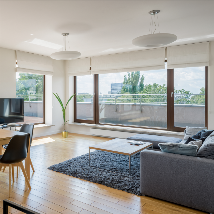 A living room with a couch a table and chairs